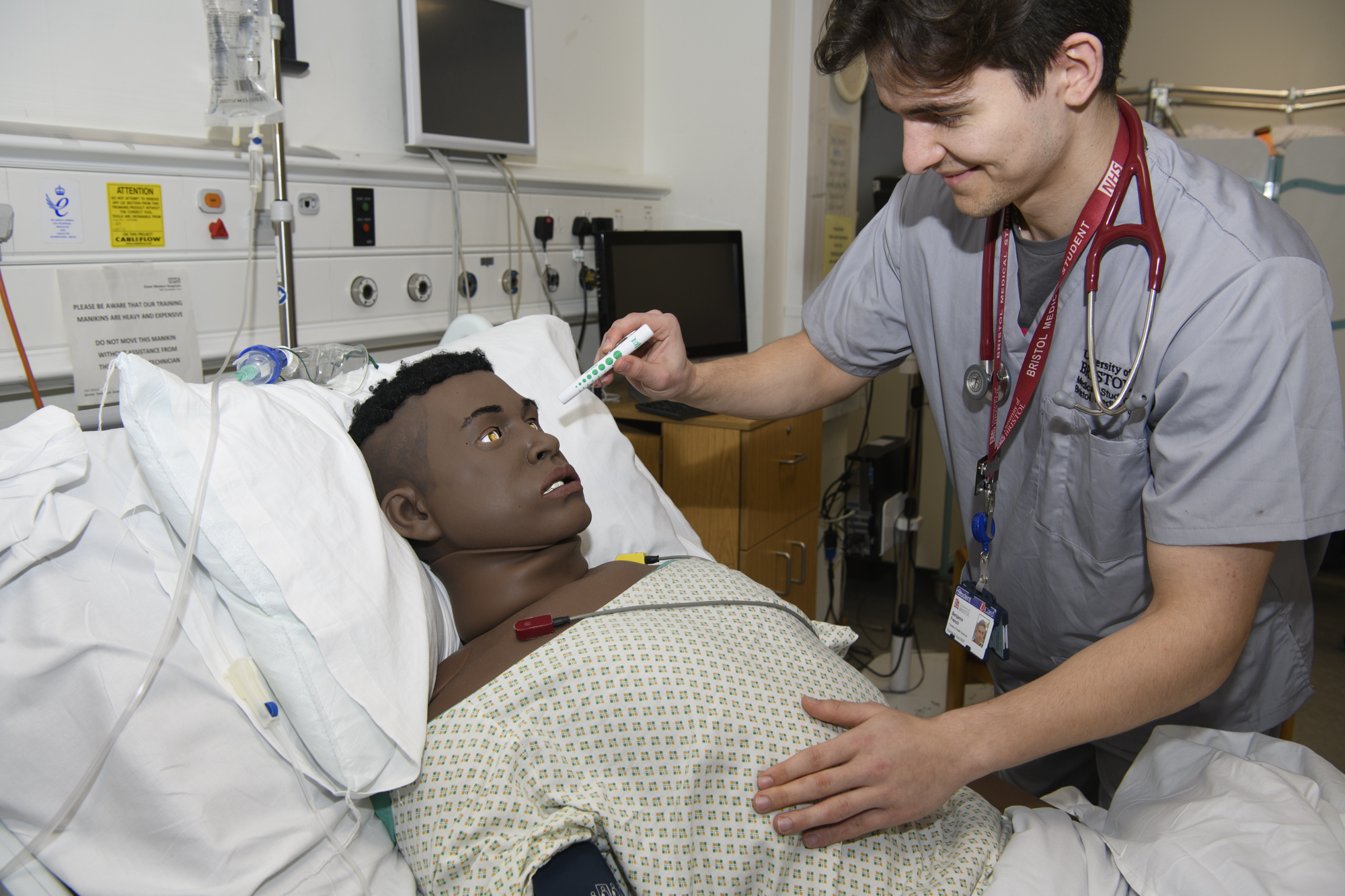 Student working with human simulation mannequin 